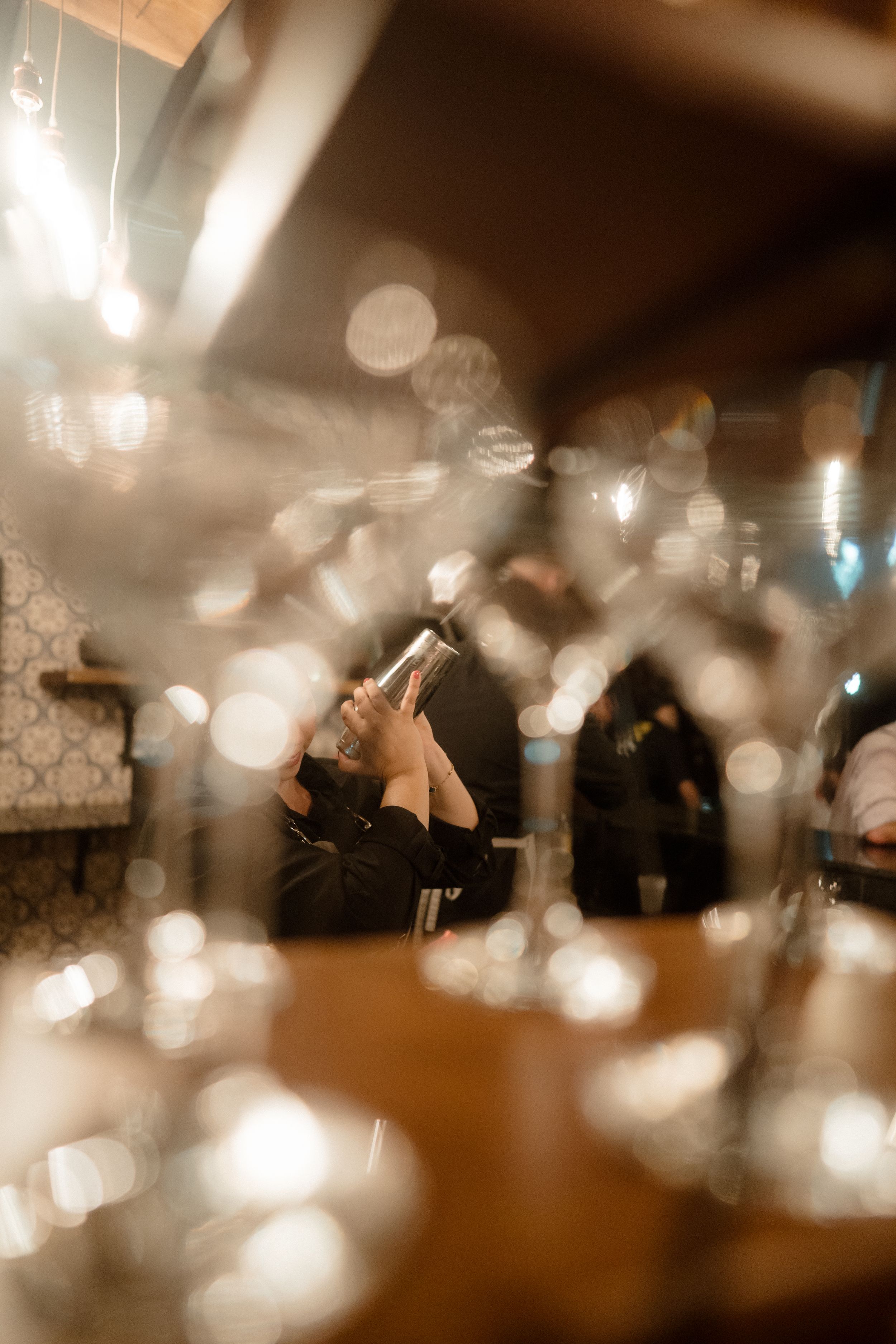 Blurred bokeh lights create a dreamy atmosphere at an indoor event.