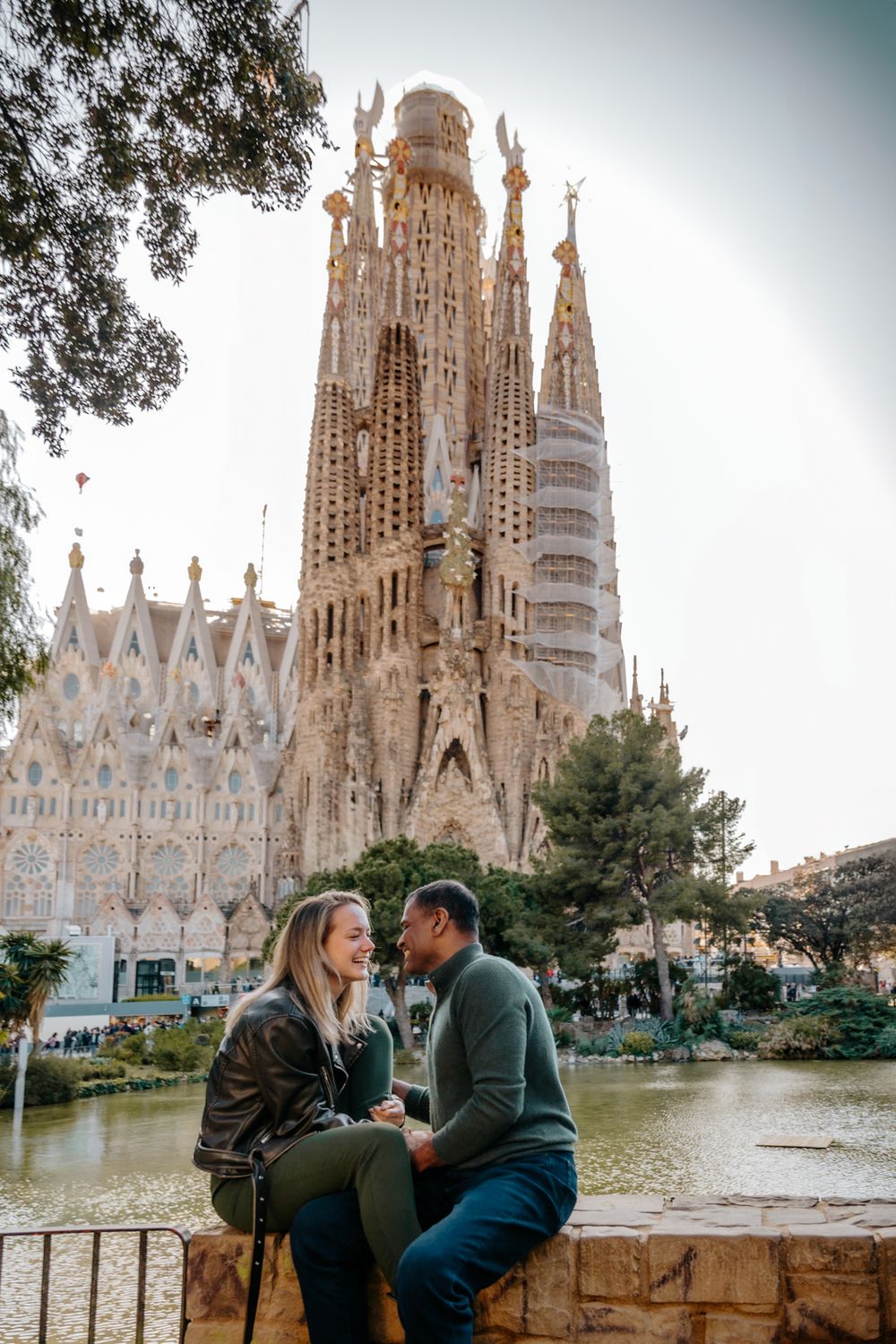 Julia leaning gently on Deepak’s shoulder with the cathedral in the background.