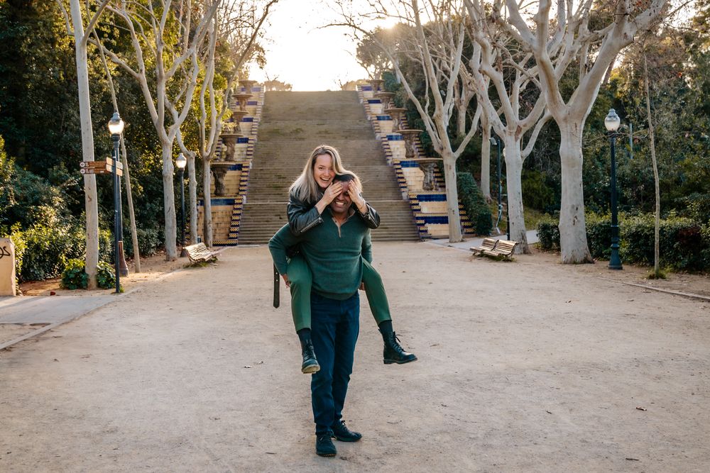 Candid moment as they joke and laugh while walking hand in hand.