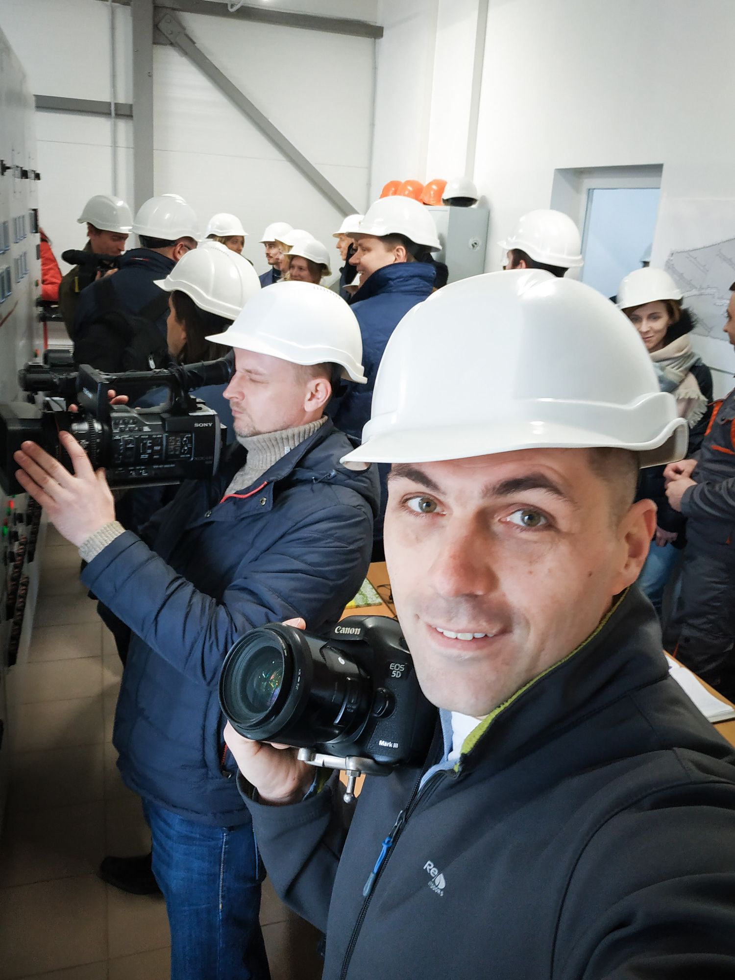Alex Rezin filming on location at an industrial facility