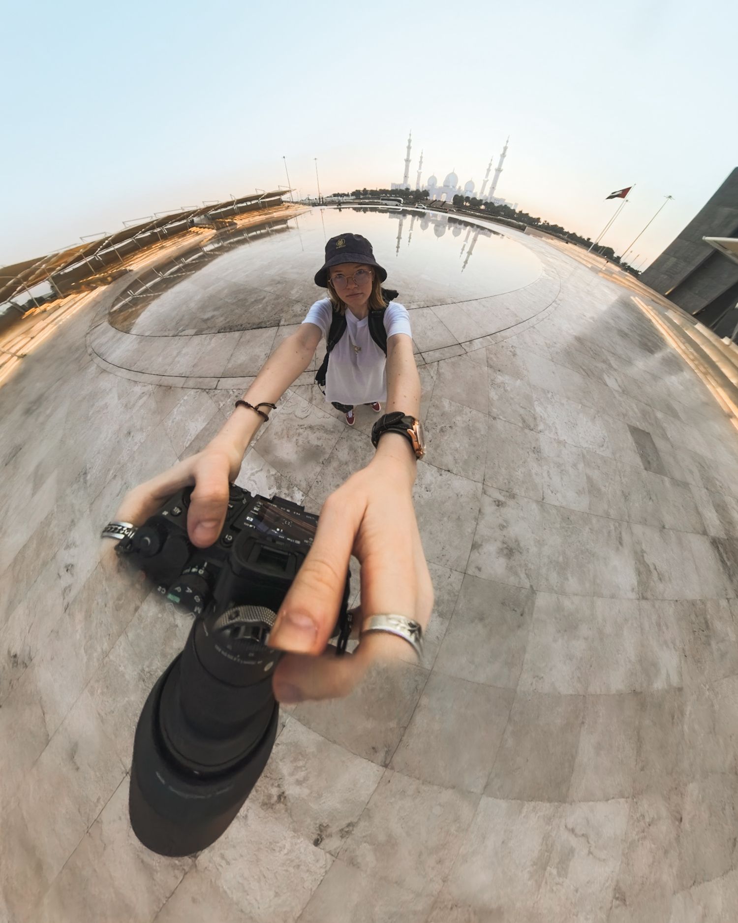 Kairiin, K Stuudio Photography in Abu Dhabi, taking a photo of herself, her camera and Sheikh Zayed Grand Mosque during sunset