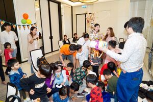 A lively children's party with attendees gathered in a bright indoor space.
