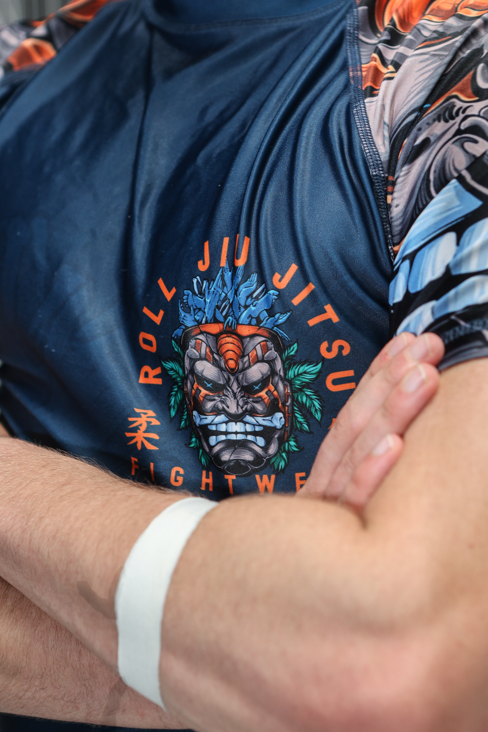 Close-up of Roll Jiu Jitsu Fightware navy rashguard with fierce oni mask graphic design.