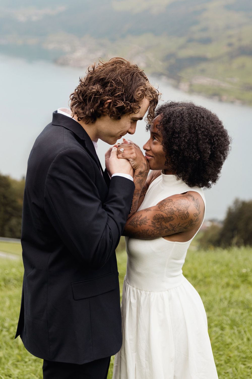 Close-up emotional portrait of a couple embracing and smiling after a marriage proposal.