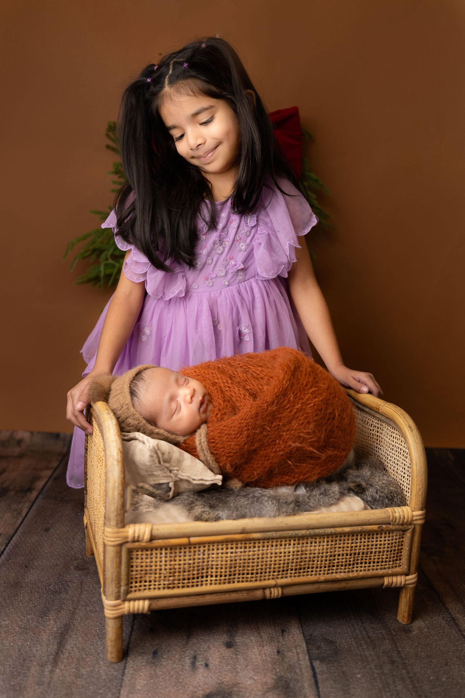Newborn photography session at Meena Photo Studio in Sammamish WA — baby posed in wrap within first 14 days