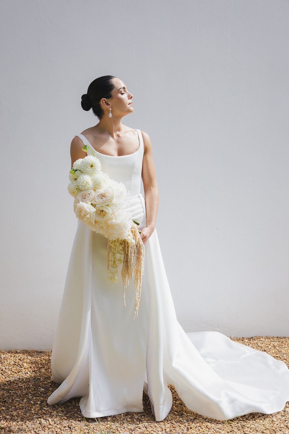 Timeless bridal portrait featuring modern wedding dress and soft textures