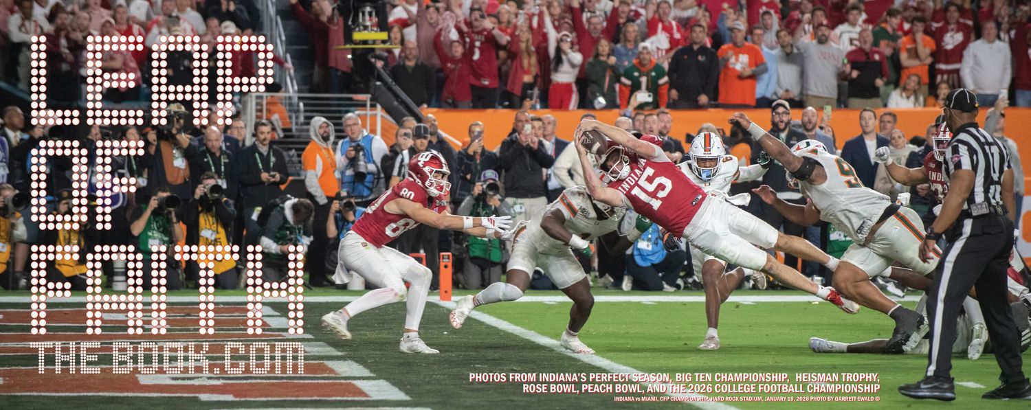 Football game action showing Indiana University quarterback diving dramatically into the end zone in the national championship game.