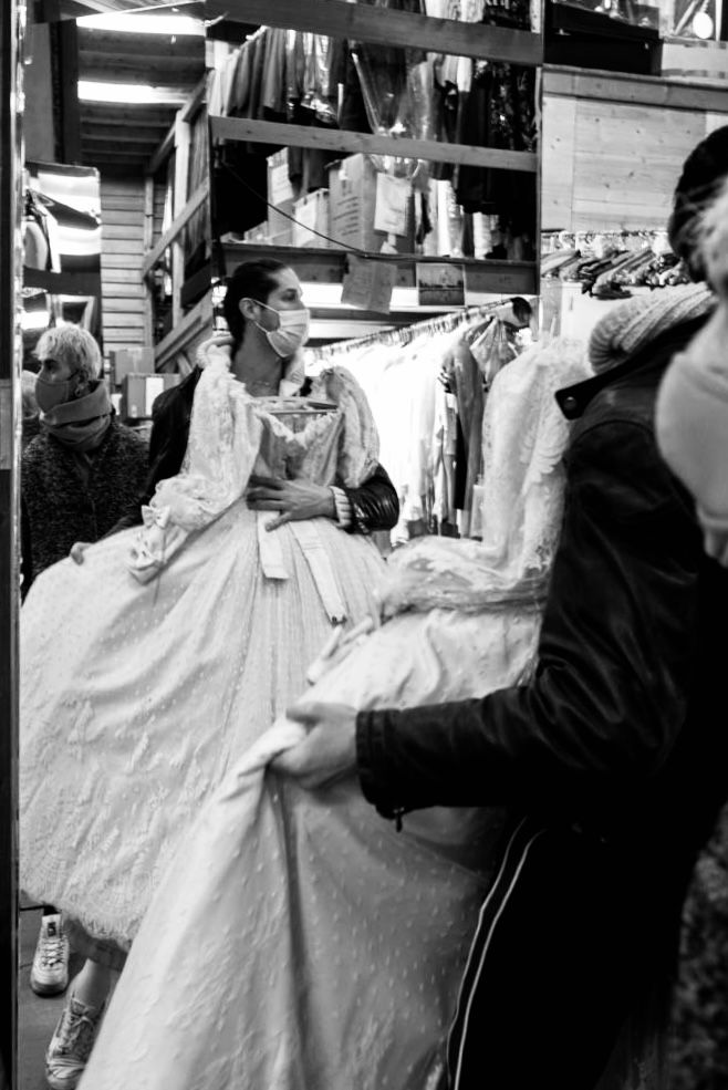 Black and white photo of a person in a white stage dress trying it on in a Geneva grand theatre.