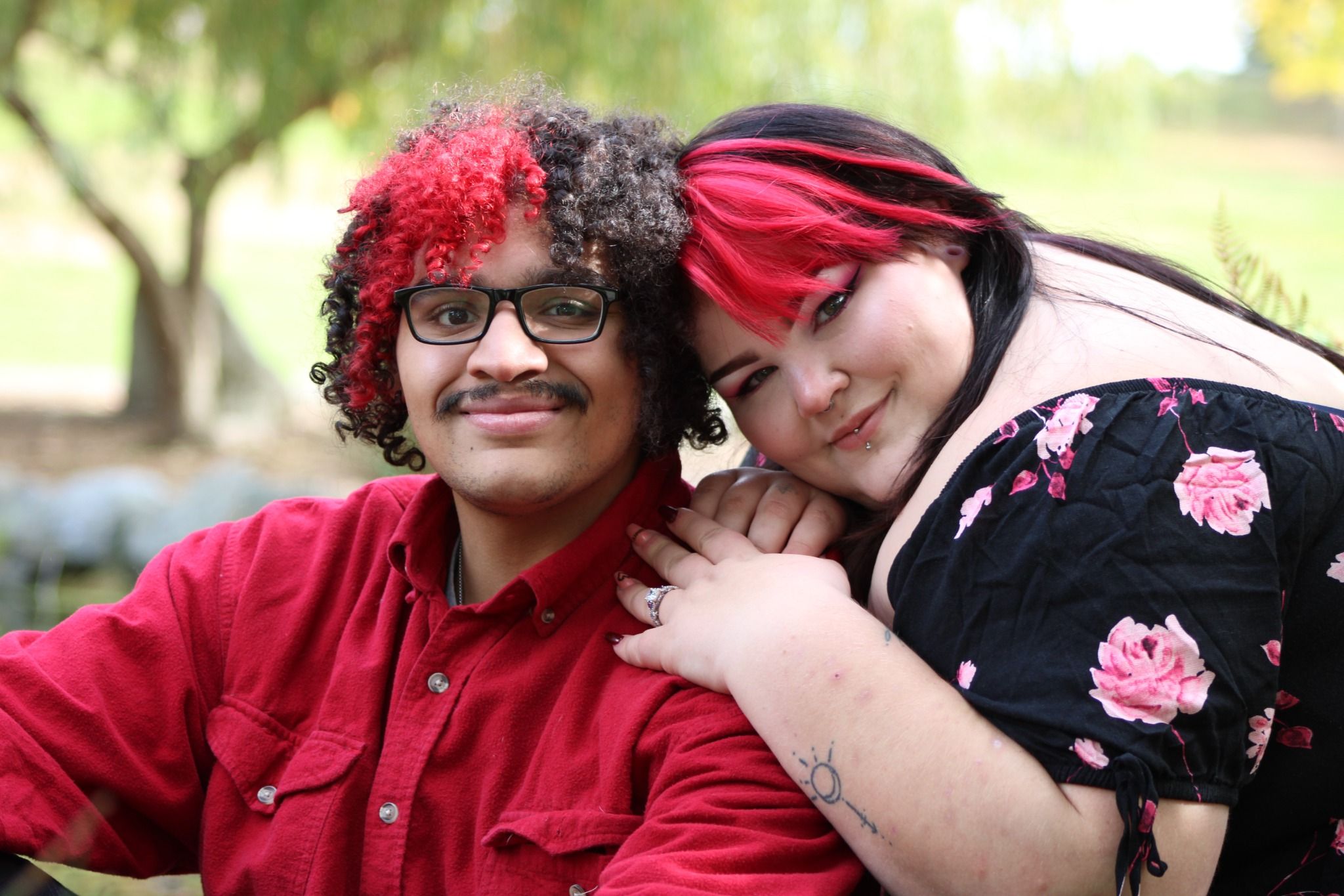 Close-up of couple leaning together with soft smiles during a romantic outdoor photo session
