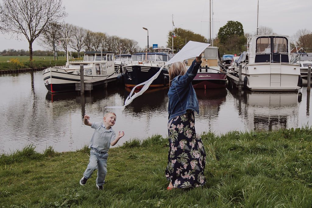 Children laughing and running around with grandmother who visited from South Africa during outdoor photoshoot in the Netherlands