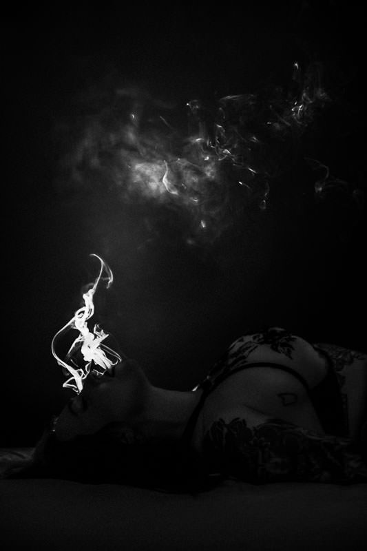 Dark black and white photograph of ethereal smoke rising against a night sky. shadow boudoir photography.