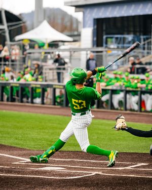 Oregon Ducks baseball player #53 in green uniform swings bat during a college baseball game at home stadium.