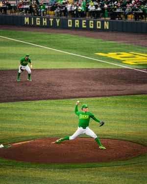 Oregon Ducks pitcher winds up on the mound at Mighty Oregon baseball stadium during a college game.