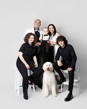 family studio portrait Sarasota white background parents with three kids and poodle clean modern timeless photography