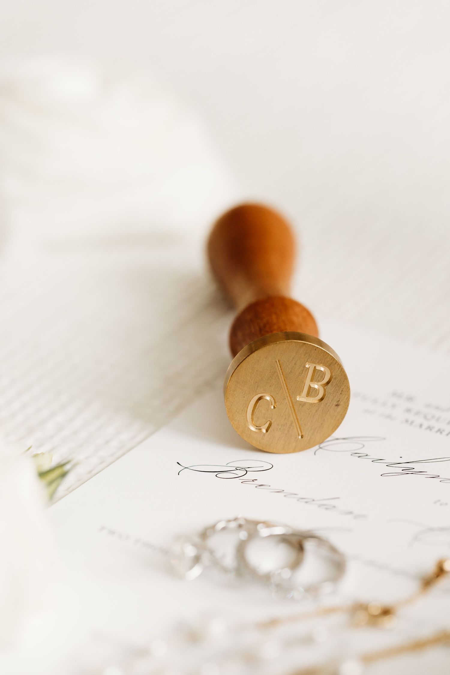 Detail image of invitation and personalized wax seal for wedding at Stow Acres Country Club in Stow, MA