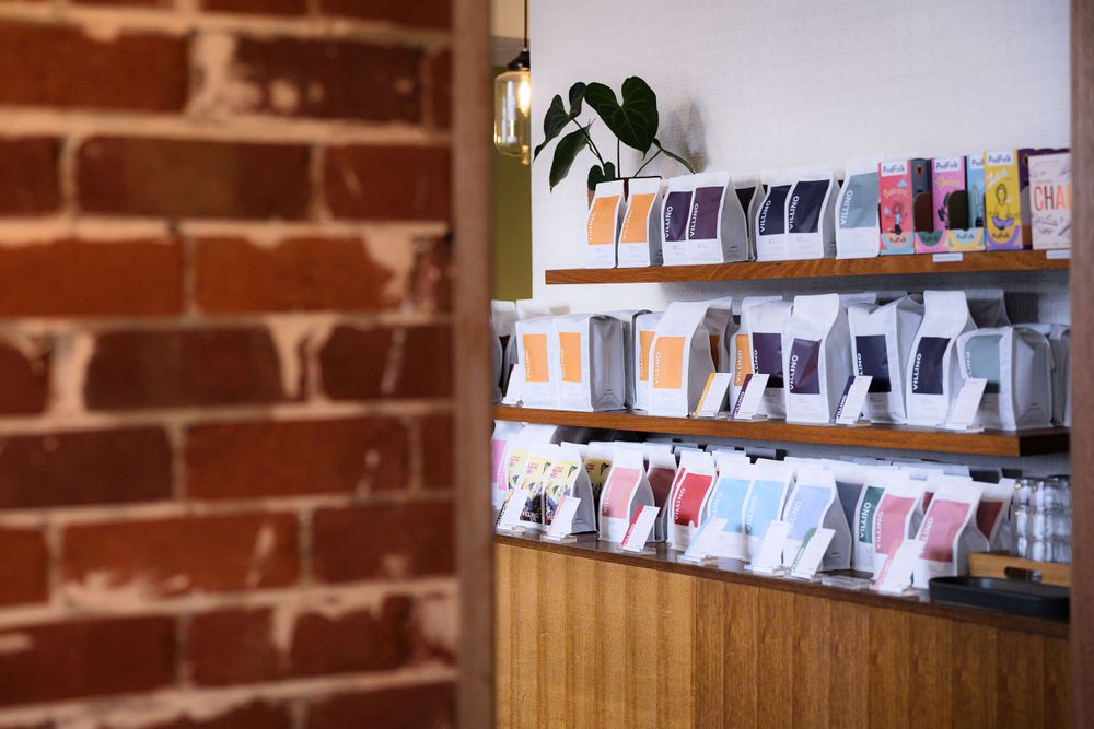 Photo prints displayed on string lines against exposed brick wall interior.