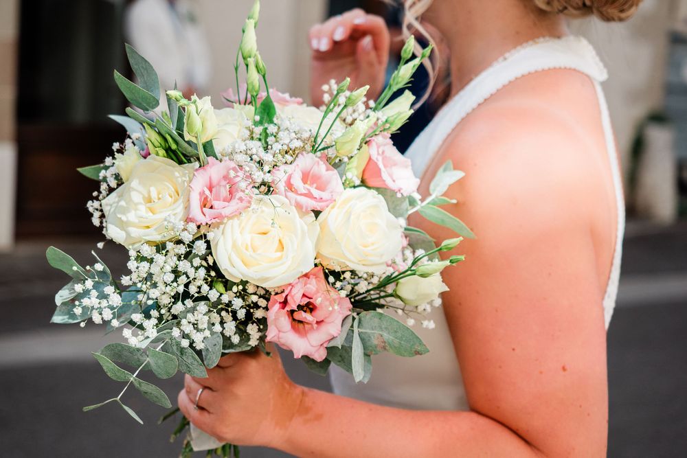 Bride holding pink and white floral bouquet of flowers in Geneva, Switzerland