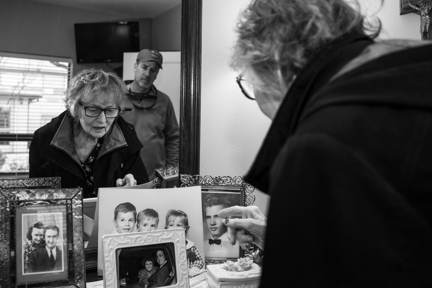 Lifestyle photo of old woman looking at old heirloom photographs taken by Jefferson County TN lifestyle photographer