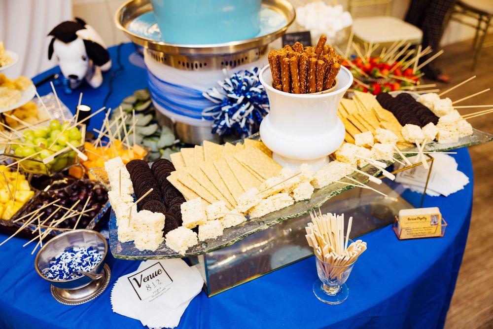 Branding session with elegant buffet spread with blue decor featuring desserts and appetizers.