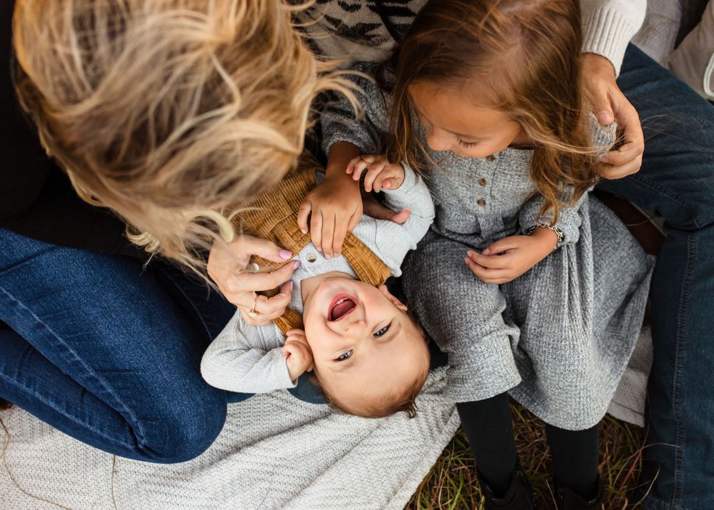 A candid shot showing tender moments between parent and child playing together outdoors.