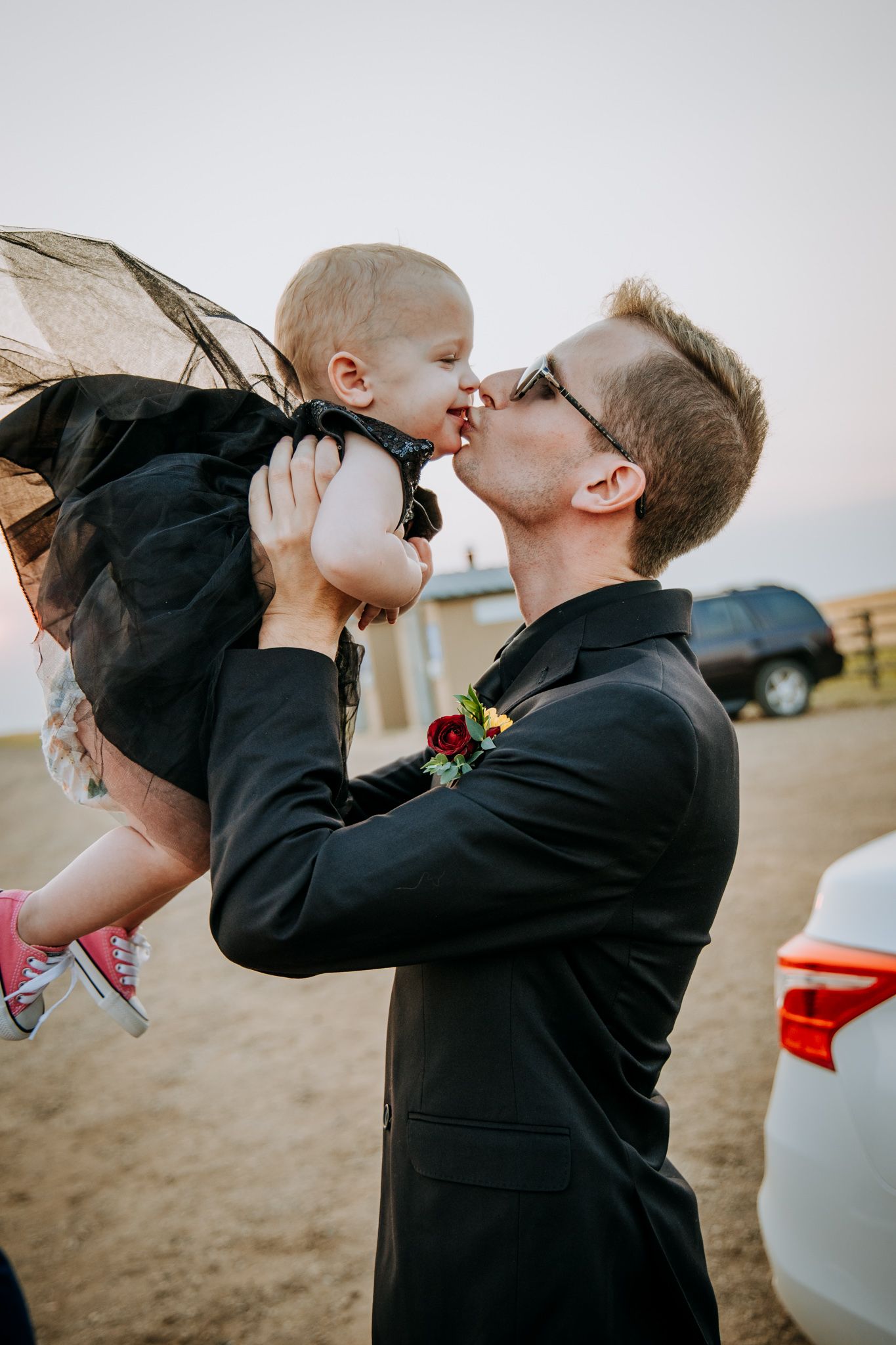 Tender moment between parent and child at outdoor celebration.