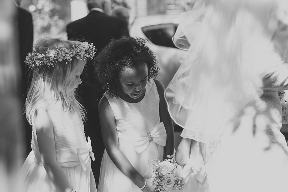 Candid wedding reception moment with guests celebrating in black and white.