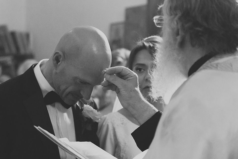 Black and white wedding photo showing an intimate moment between the couple during their celebration.