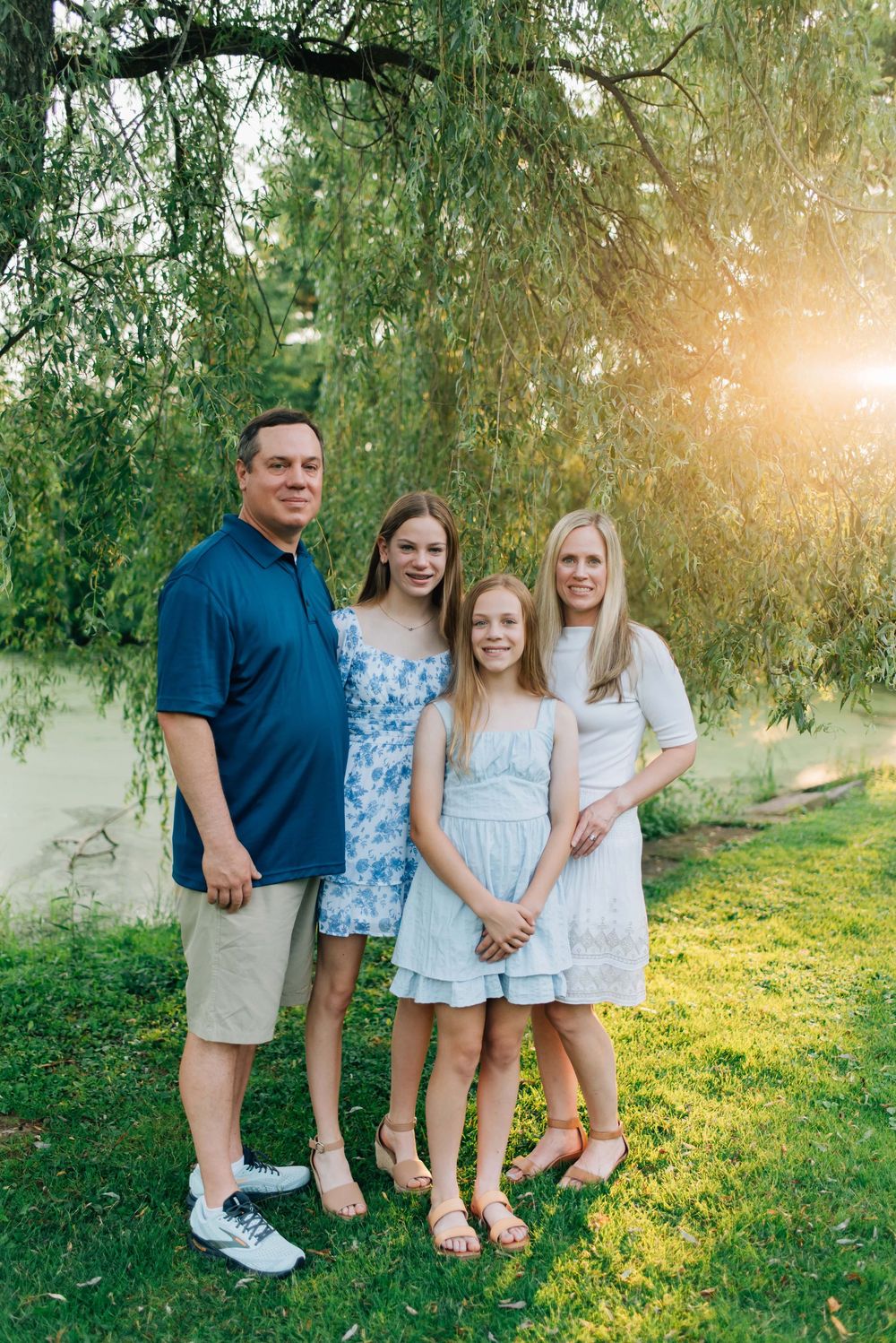 Family standing under willow tree in summer sunlight in Pittsburgh, PA