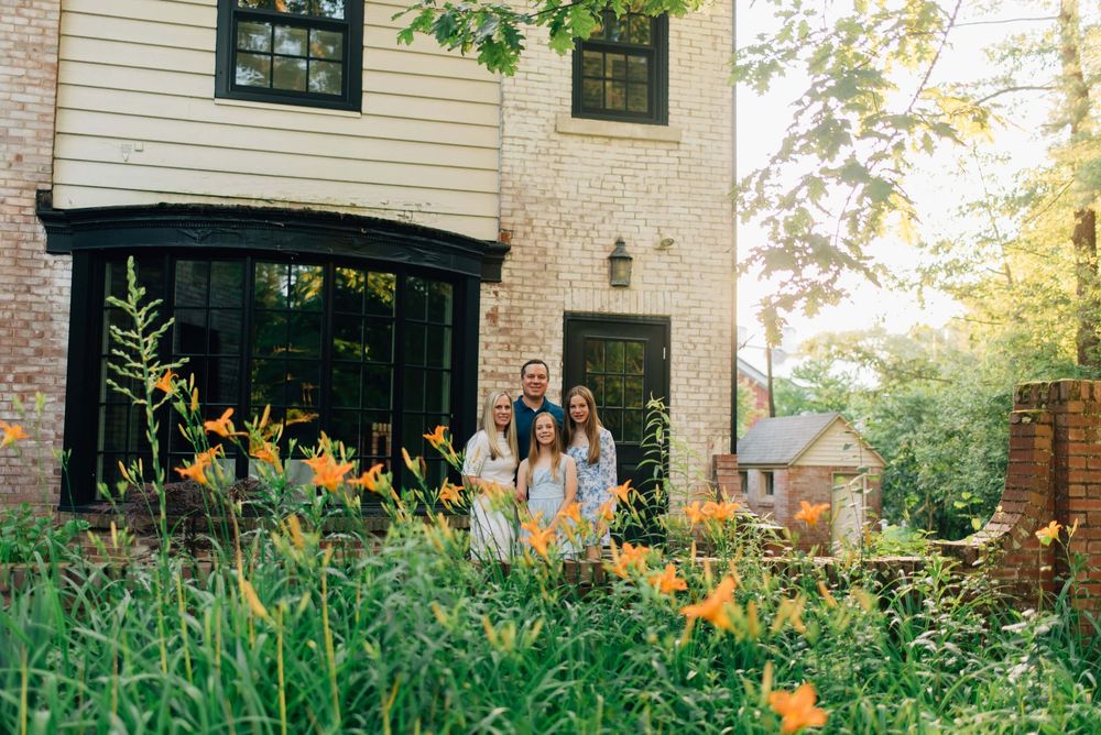 Family standing near flowers in the summer at Succop Nature Park