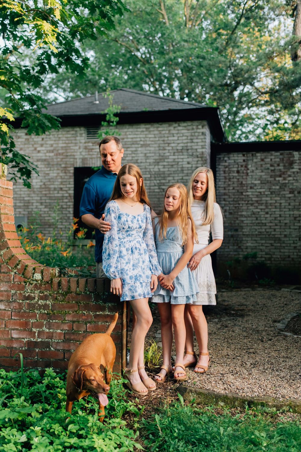 Family laughing at dog in the summer in Pittsburgh, PA