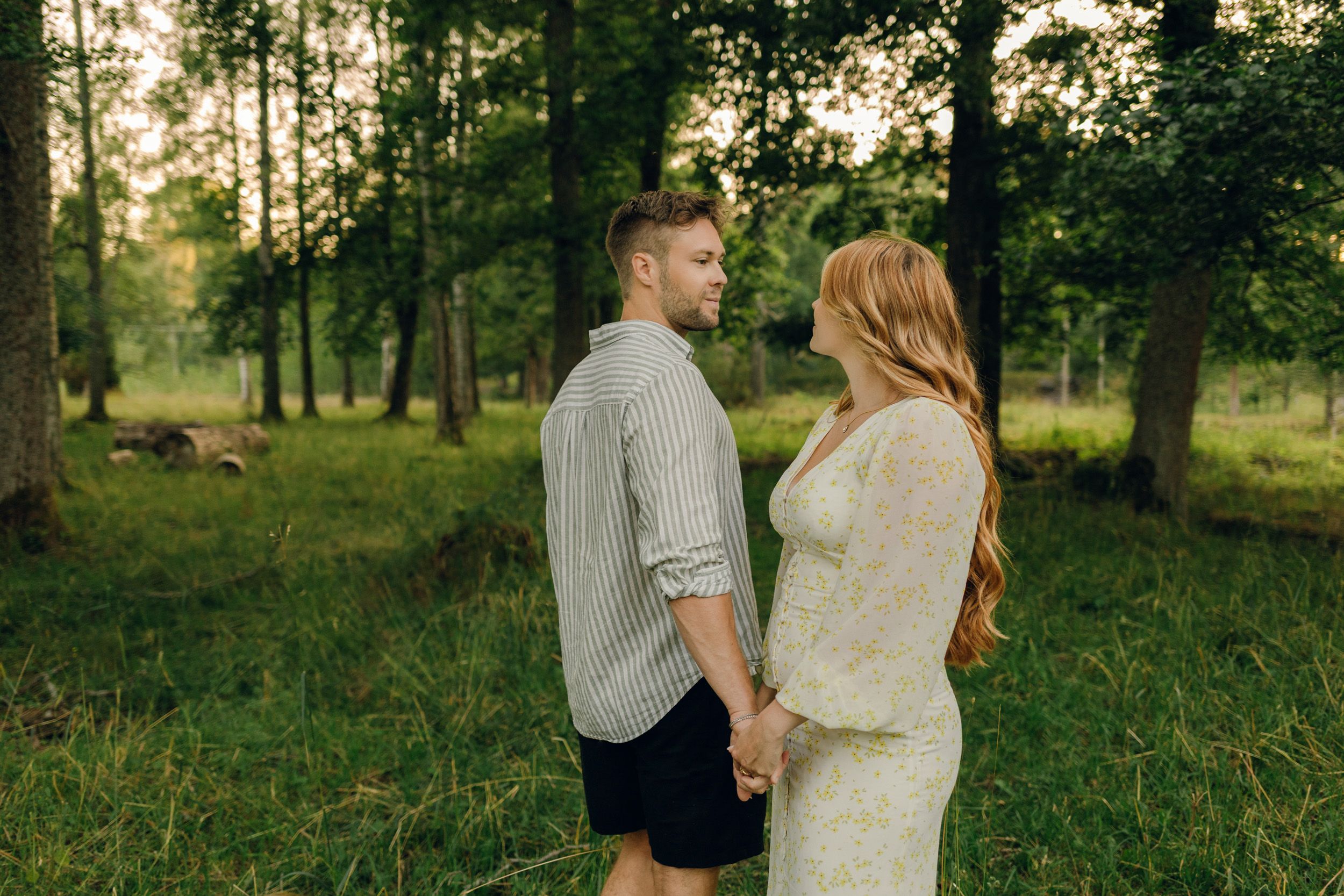 Parfotografering med Martina och Sebastian i Borgvik utanför Karlstad. Tittar på varandra i skog.