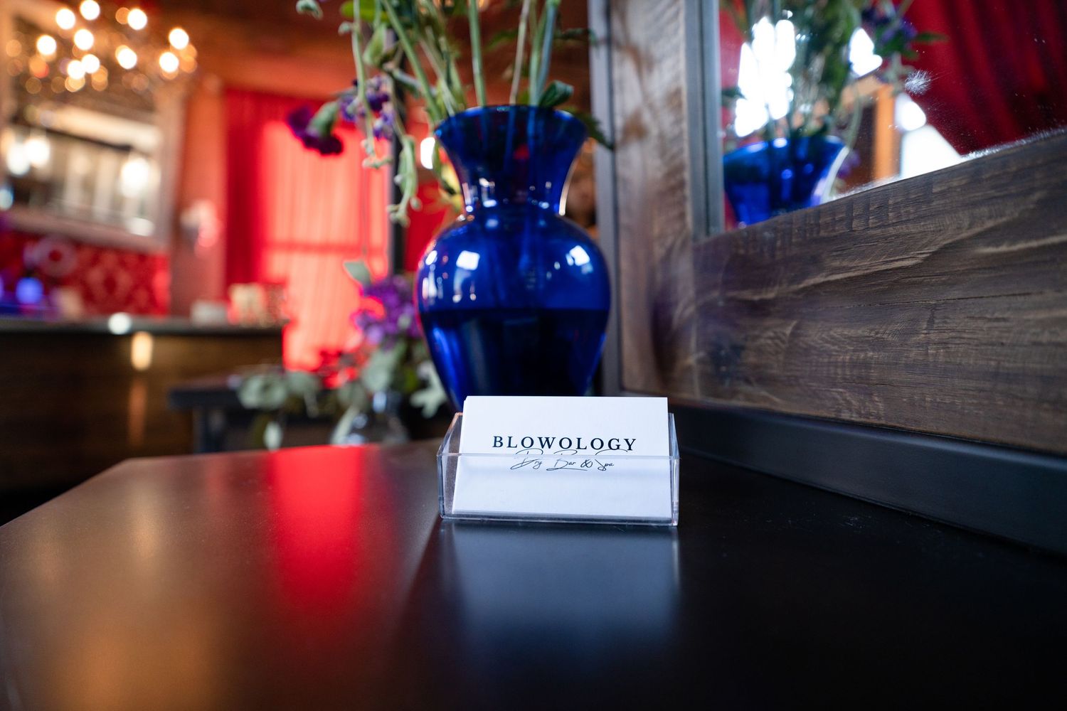 Blurred bokeh lights and decorative elements create an atmospheric ambiance in a dimly lit restaurant setting.