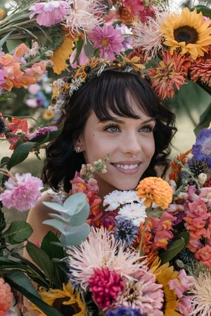 Colorful floral arrangement with sunflowers, dahlias, and wildflowers creates vibrant frame.