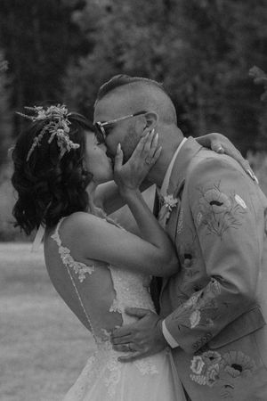 A romantic series of black and white wedding photos showing a couple embracing and kissing outdoors.