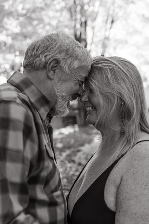 Black and white photo sequence showing a tender moment between an elderly couple sharing laughter and affection.