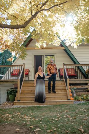 A series of five sequential photos showing people dancing in a line on a wooden deck with autumn leaves in the background.
