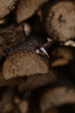Close-up macro photography sequence showing a diamond engagement ring and wedding band on a textured brown surface.