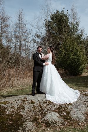 A romantic outdoor wedding photo sequence showing a couple in formal attire posing together on a winter path.