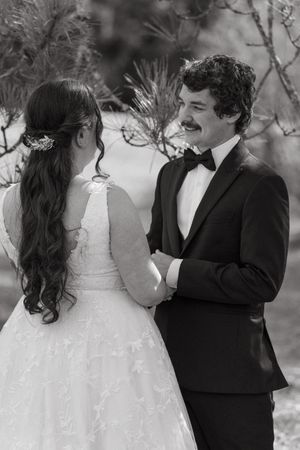 A romantic black and white wedding photo sequence shows a couple sharing tender moments together in formal attire.
