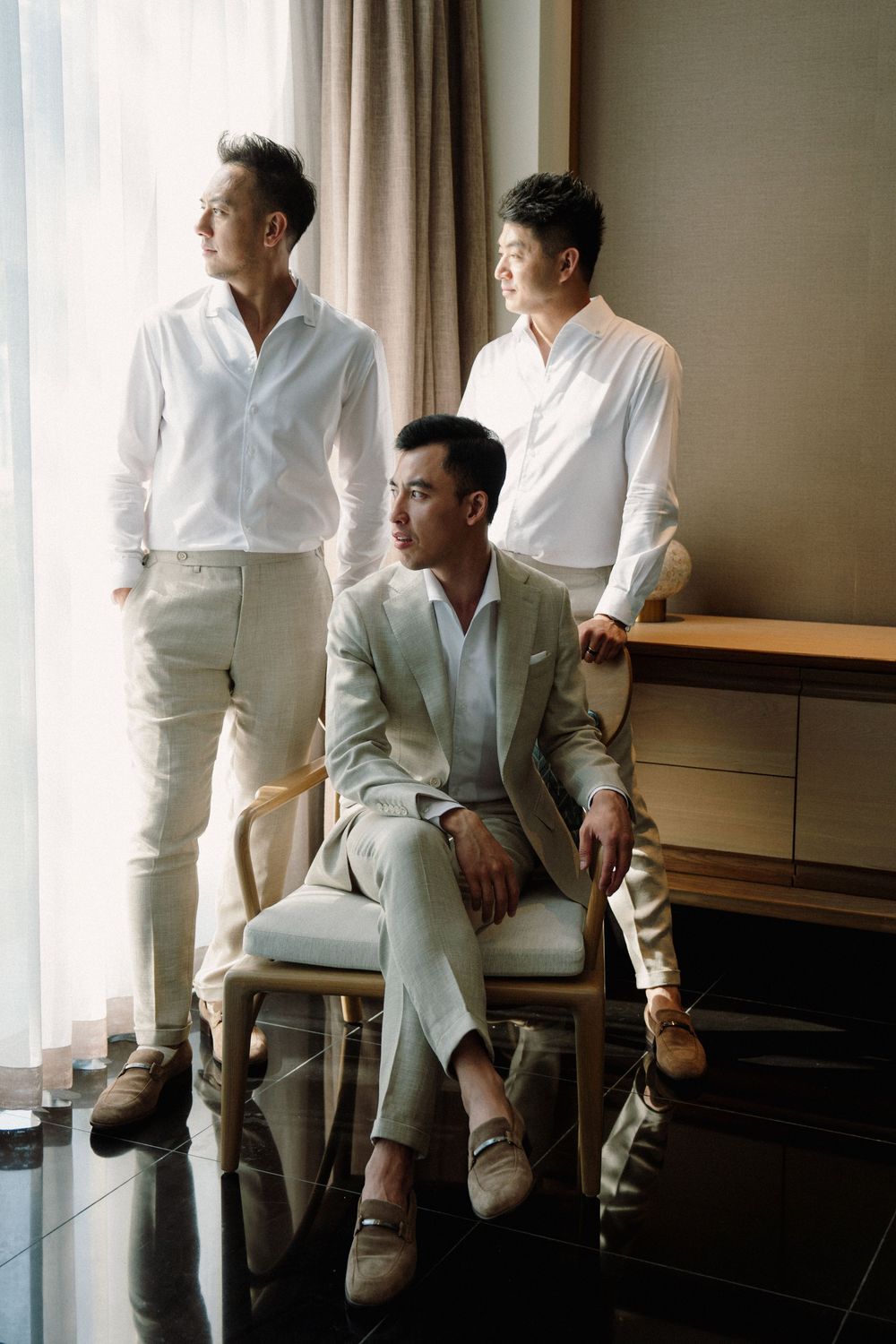 A series of candid photos showing someone in a white suit sitting by a window in an elegant room.