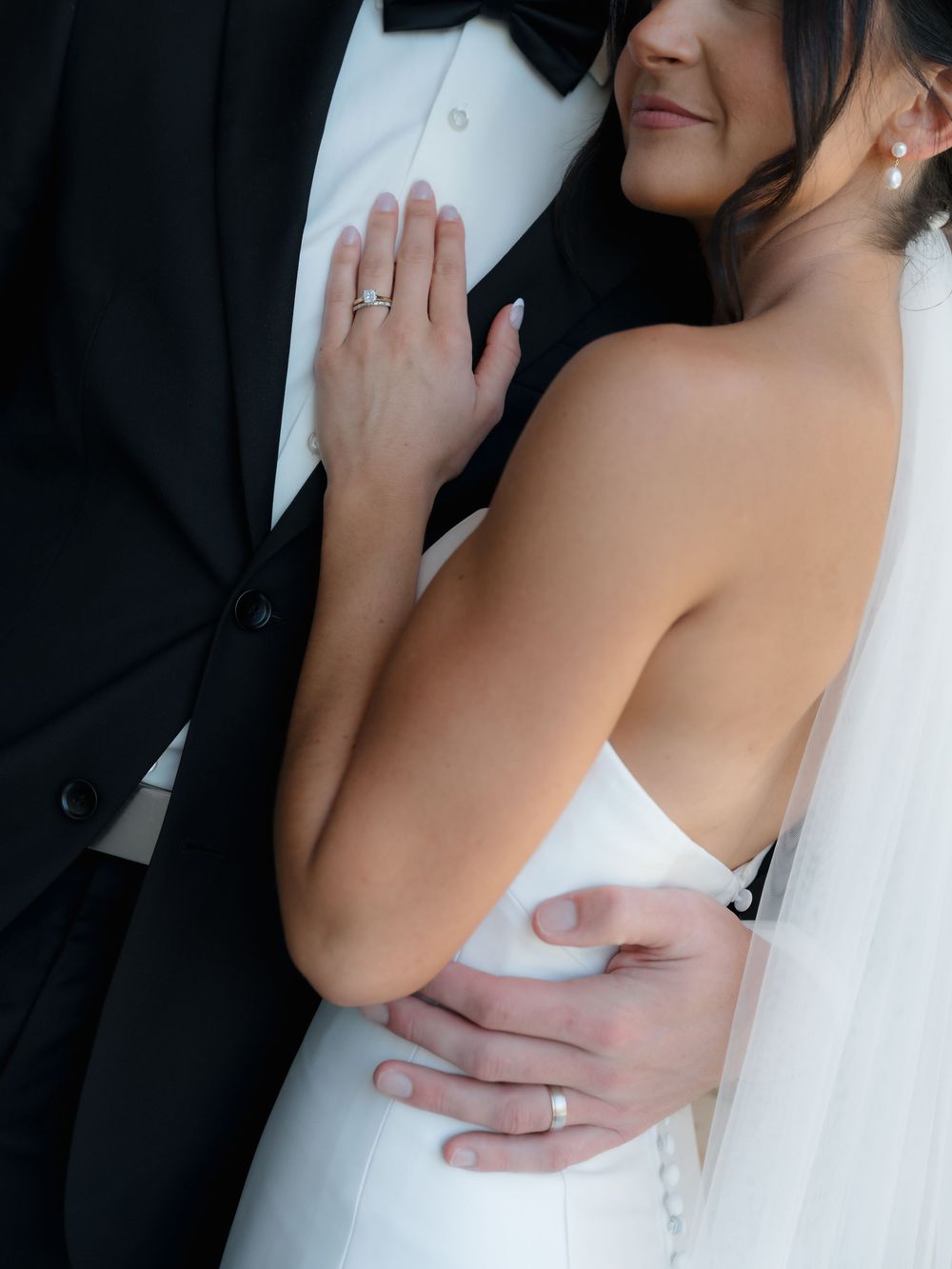 Intimate black and white wedding photos showing tender embraces between newlyweds.