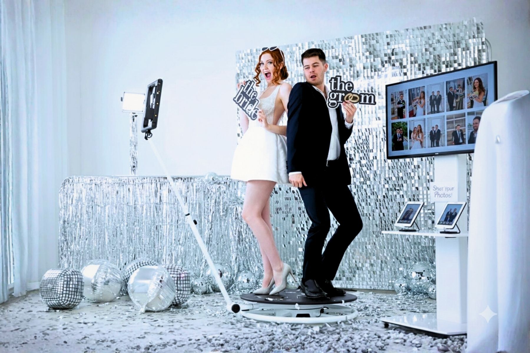 A couple dances in a room with shimmering silver wallpaper and reflective surfaces creating a glamorous atmosphere.
