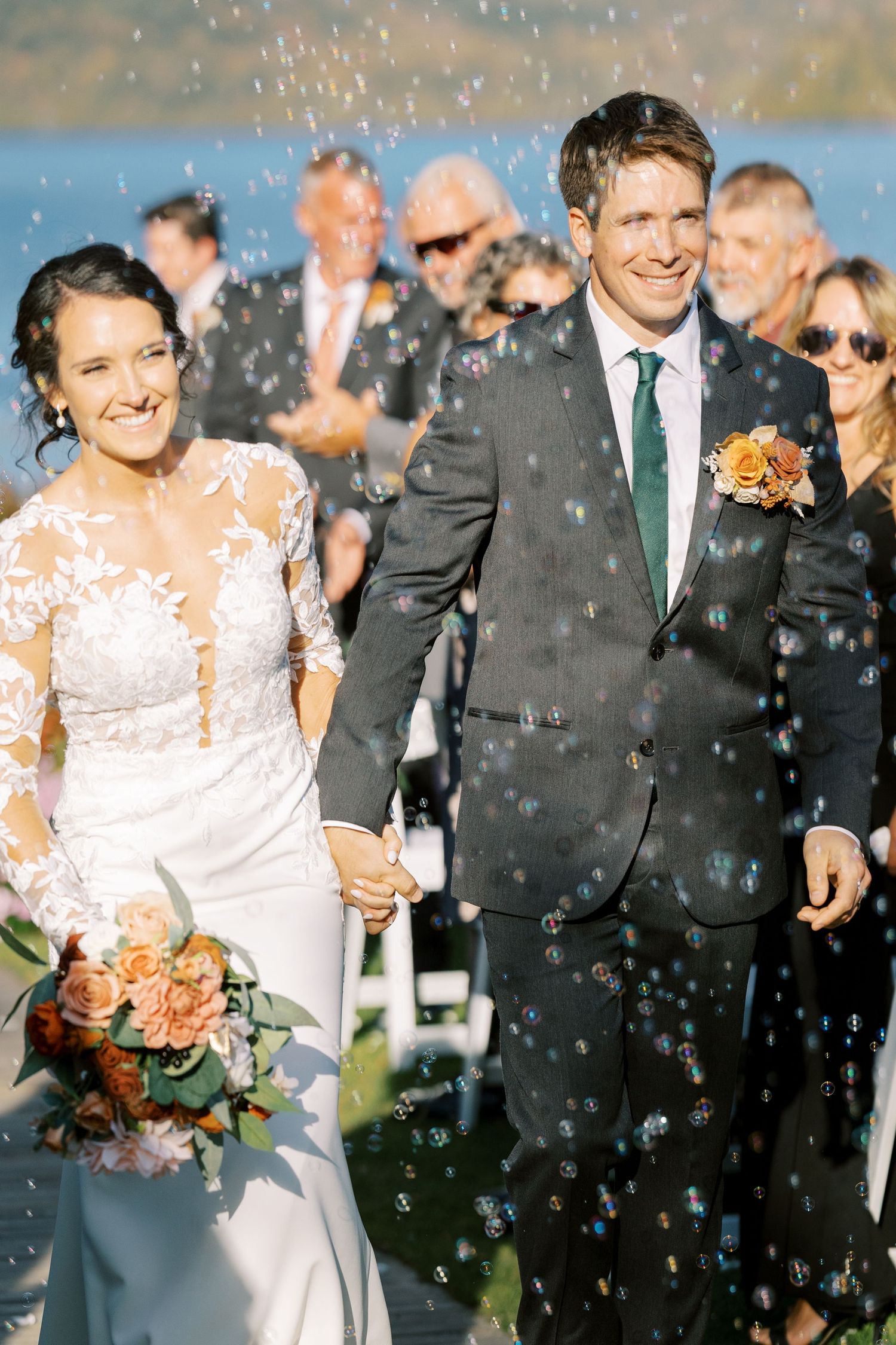 Wedding couple and guests celebrate with confetti during outdoor ceremony as they share joyful moments together.