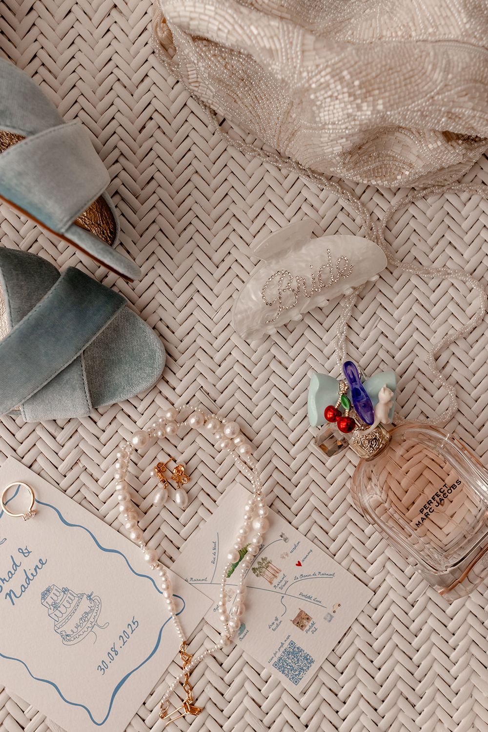 Wedding invitation cards with decorative details laid out on a textured surface.