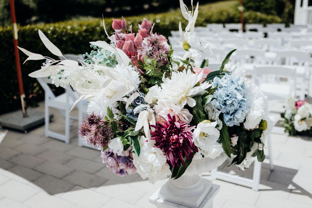 Elegant wedding reception table decorated with pink, purple and white floral arrangements and crystal glassware.