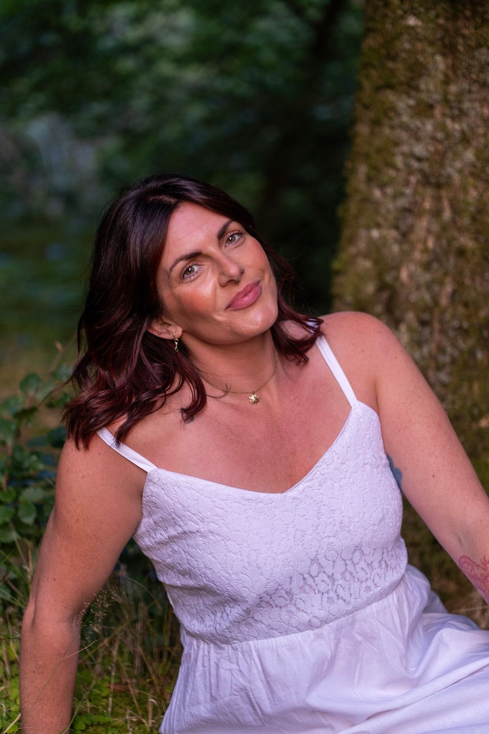 A series of outdoor portraits showing a person in a white lace dress posing against a natural backdrop.