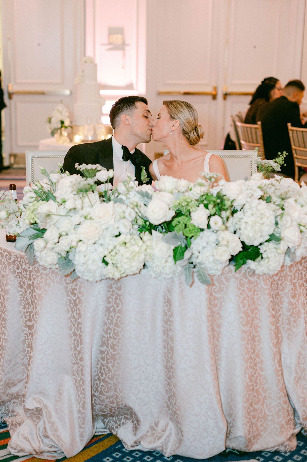 Elegant wedding reception table decorated with white hydrangea centerpieces and sequined tablecloths at a Willard Hotel wedding