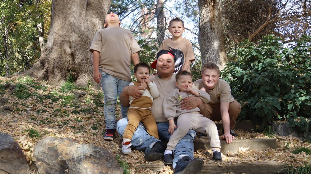 Family gathered together outdoors during a natural light family photo session