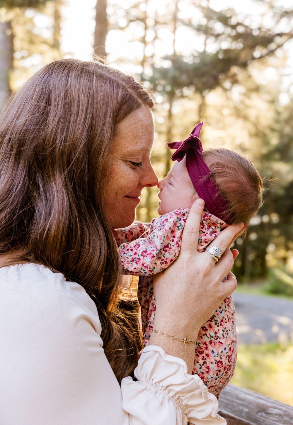 A series of tender moments between parent and baby captured in warm sunlight during an outdoor photoshoot.