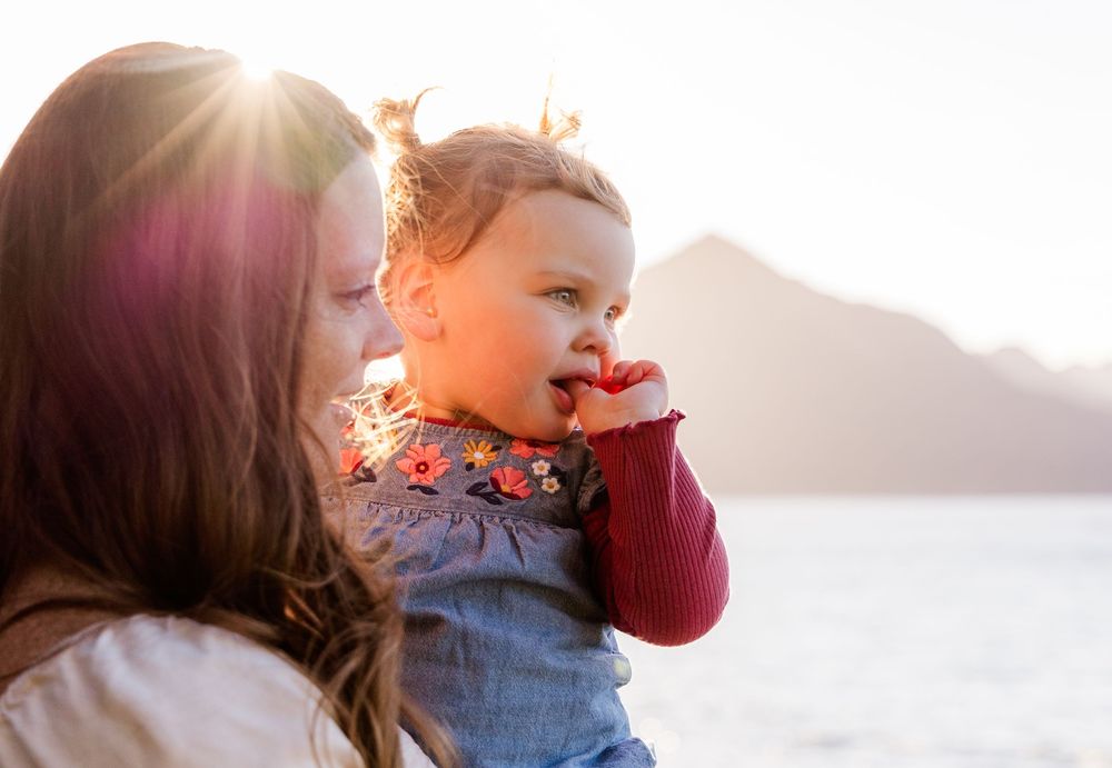 A series of candid sunset silhouettes showing tender family moments at golden hour on the beach.